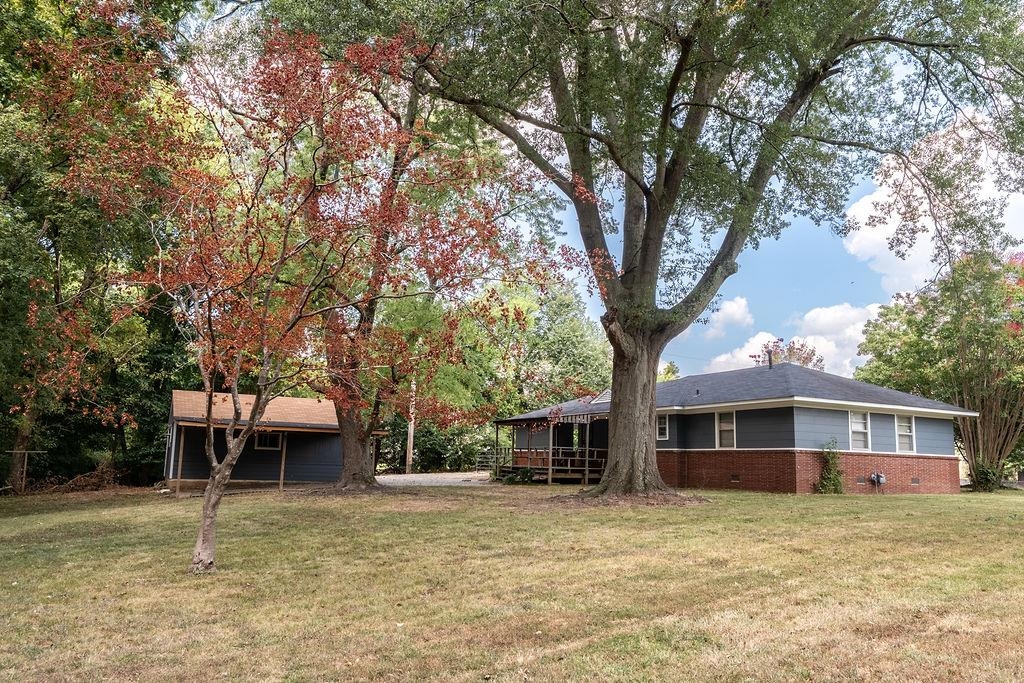 5595 Raleigh Lagrange Road Memphis, TN 38134 - Photo 6 of 29 a front view of a house with a yard