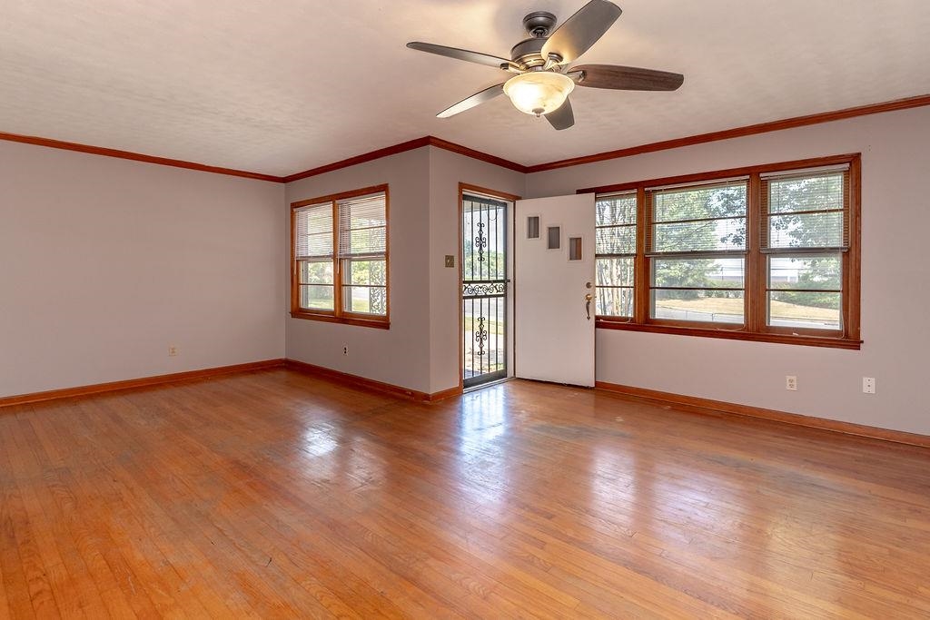5595 Raleigh Lagrange Road Memphis, TN 38134 - Photo 8 of 29 a view of an empty room with a window and wooden floor