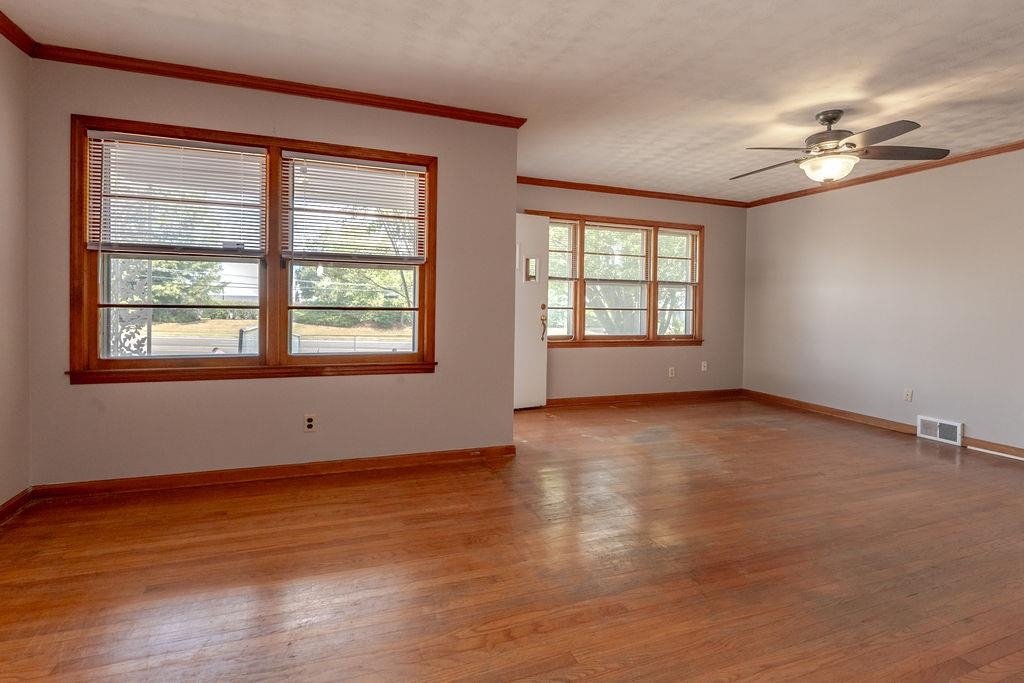 5595 Raleigh Lagrange Road Memphis, TN 38134 - Photo 9 of 29 a view of an empty room with wooden floor and a window