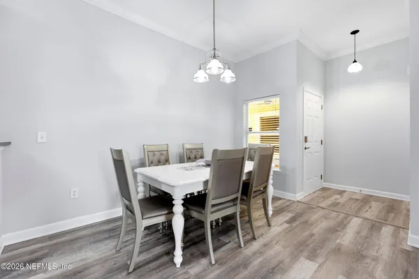 a view of a dining room with furniture window and wooden floor
