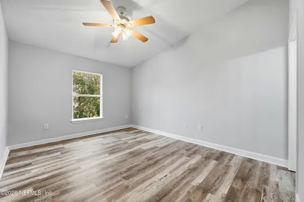 wooden floor in an empty room with a window