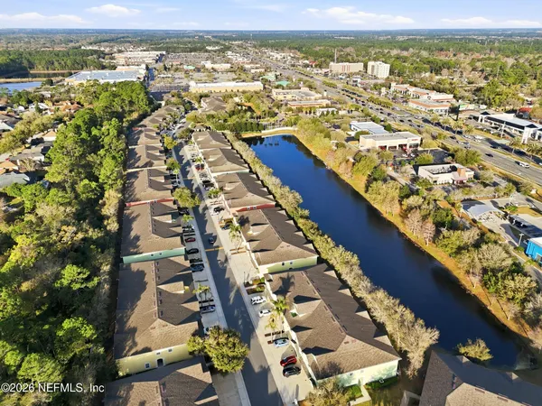 an aerial view of residential building and lake