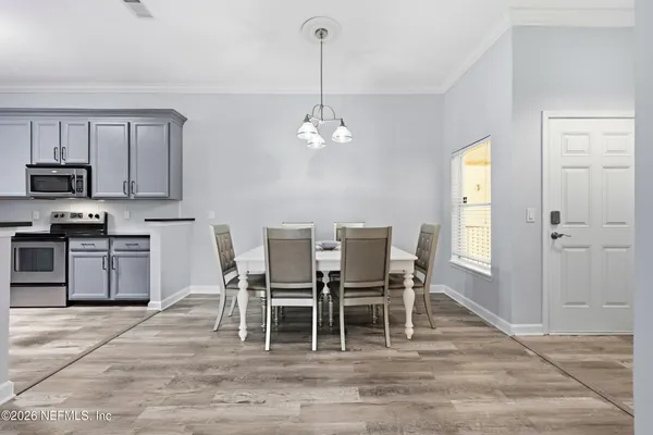 a view of a dining room with furniture and wooden floor