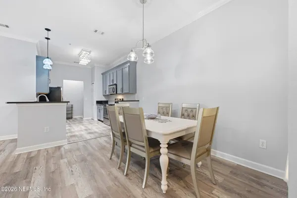 a view of a dining room with furniture and wooden floor