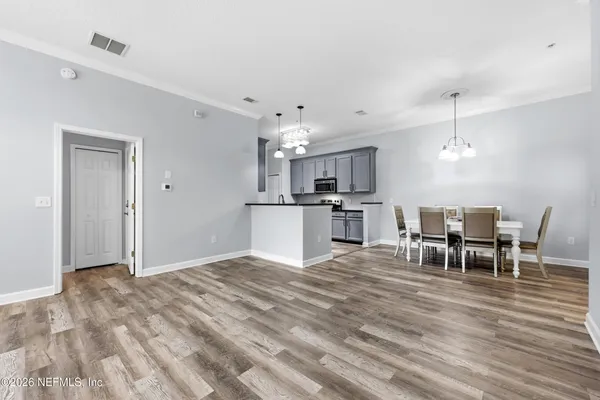 a view of kitchen with microwave and cabinets