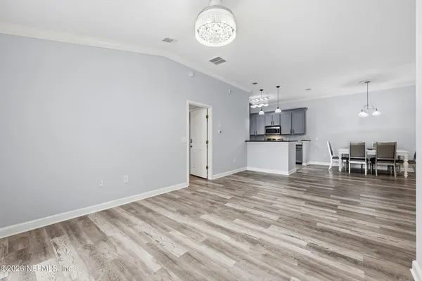a view of kitchen and dining room with wooden floor