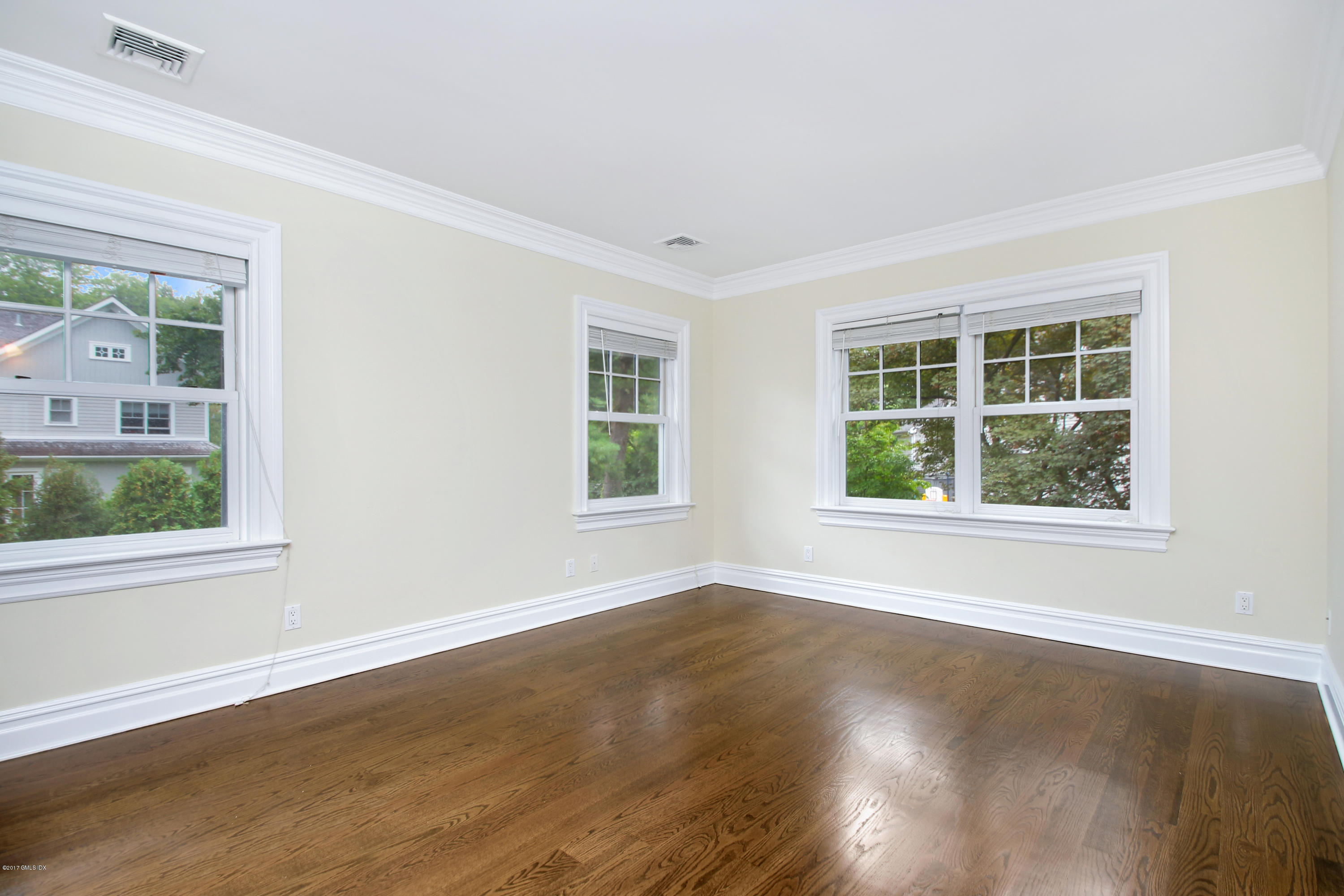 15 Juniper Lane Riverside, CT 06878 - Photo 17 of 36 an empty room with wooden floor and windows