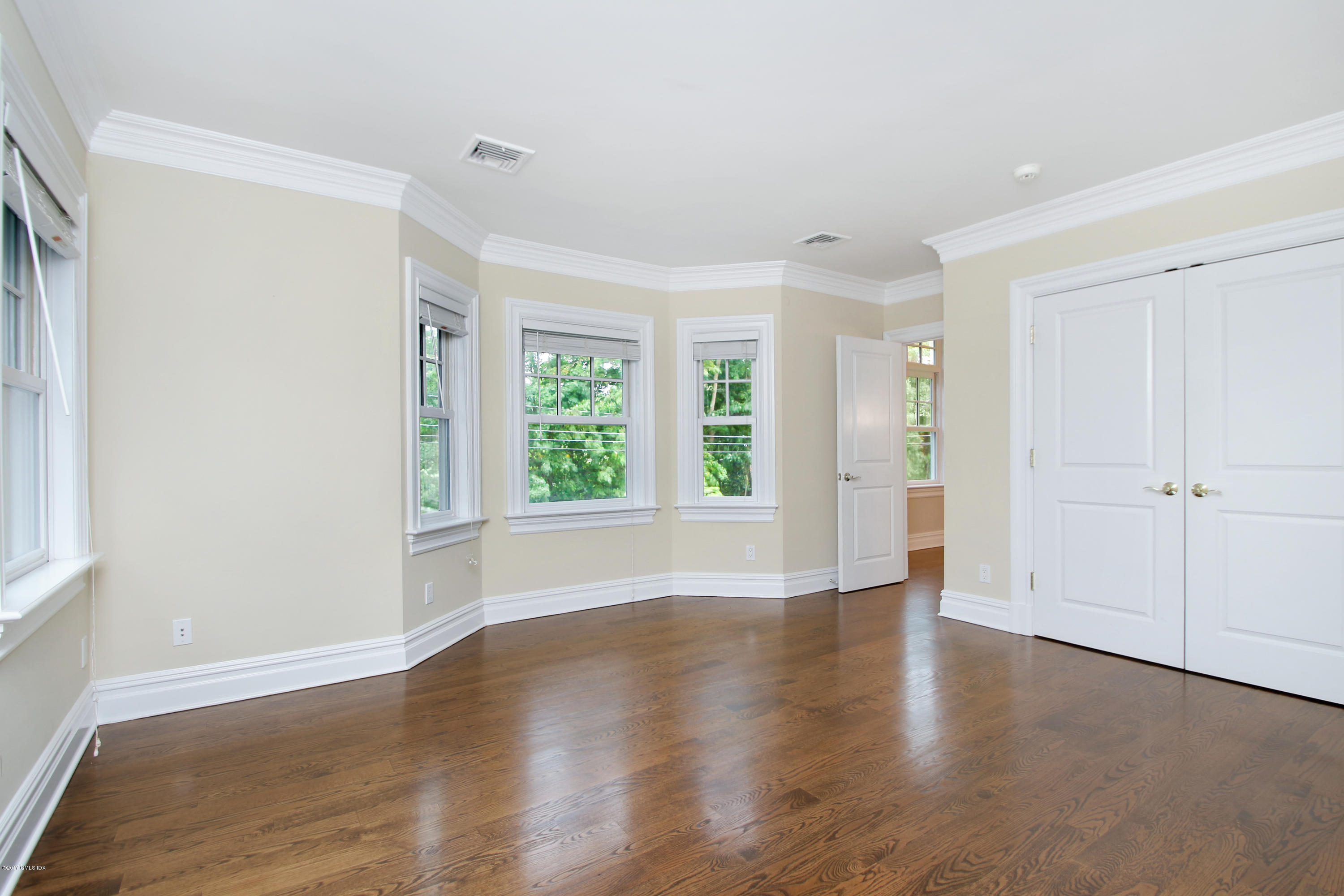 15 Juniper Lane Riverside, CT 06878 - Photo 19 of 36 an empty room with wooden floor and windows