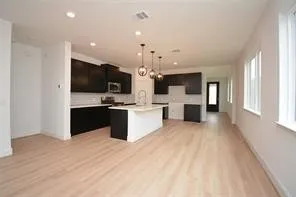 a large white kitchen with cabinets and stainless steel appliances