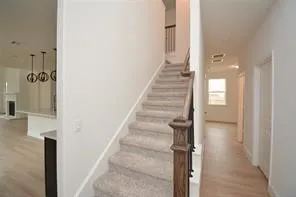 a view of a hallway with wooden floor and entryway