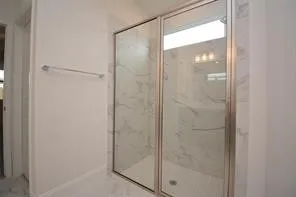a bathroom with a glass shower door