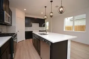 a kitchen with a stove cabinets and wooden floor