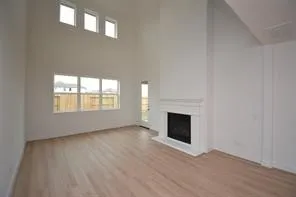an empty room with fireplace and windows