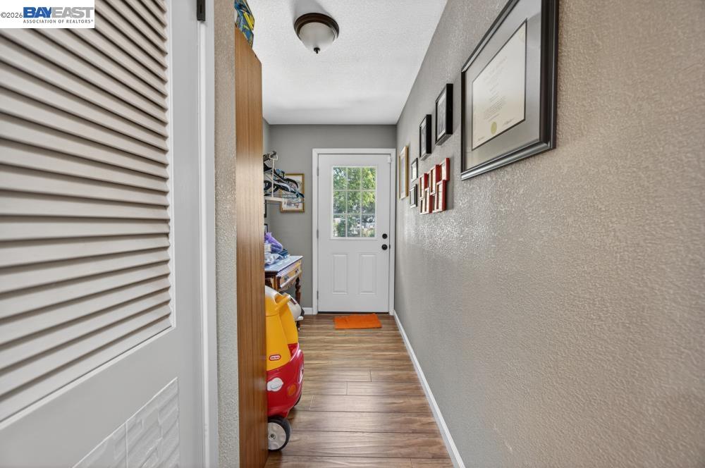 3590 Park Road Sacramento, CA 95841 - Photo 35 of 66 a view of a hallway with wooden floor and staircase