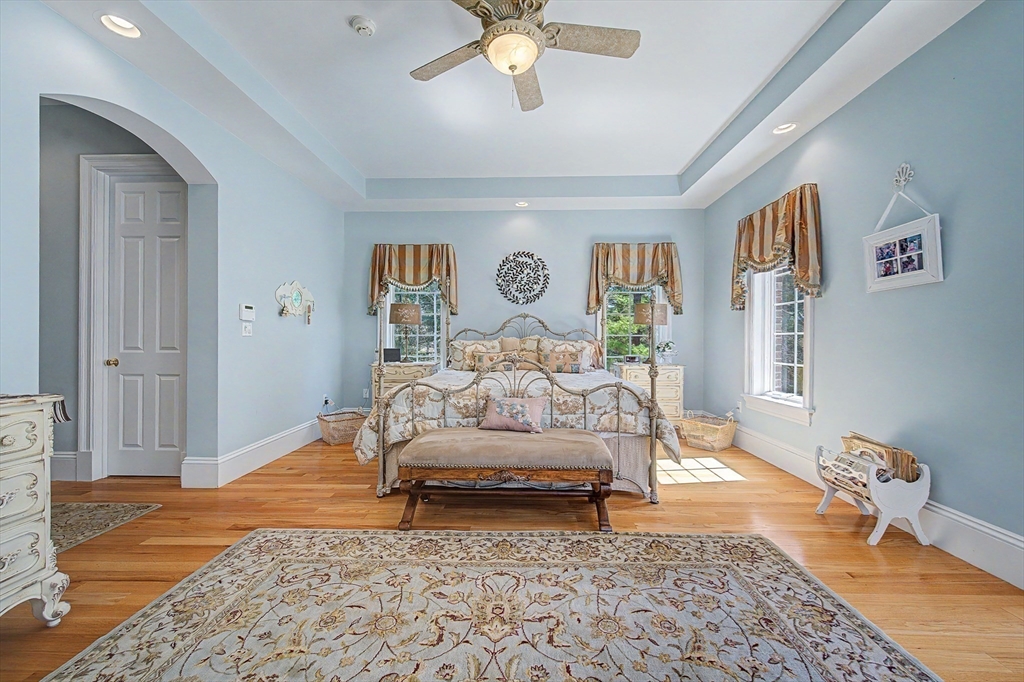 6 Trailside Way Norfolk, MA 02056 - Photo 26 of 42 a bedroom with a bed and a chandelier