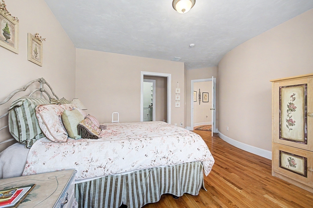 6 Trailside Way Norfolk, MA 02056 - Photo 30 of 42 a bedroom with a bed and wooden floor