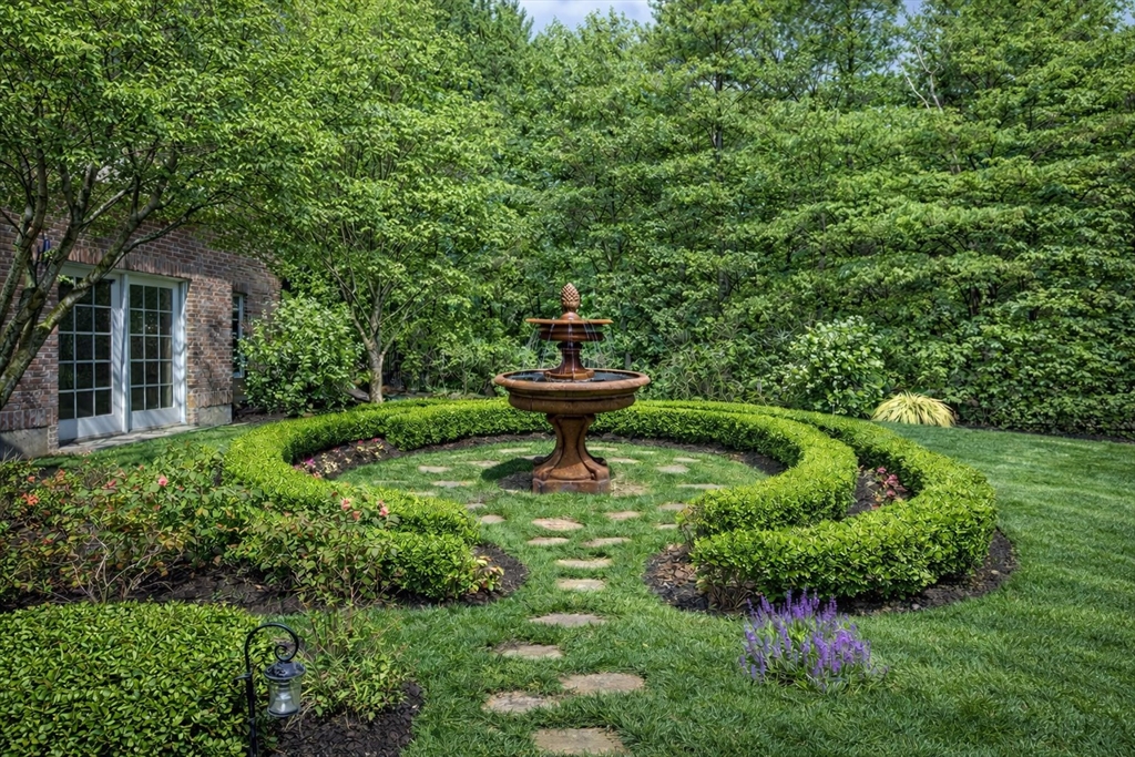 6 Trailside Way Norfolk, MA 02056 - Photo 39 of 42 a view of a garden with a fountain