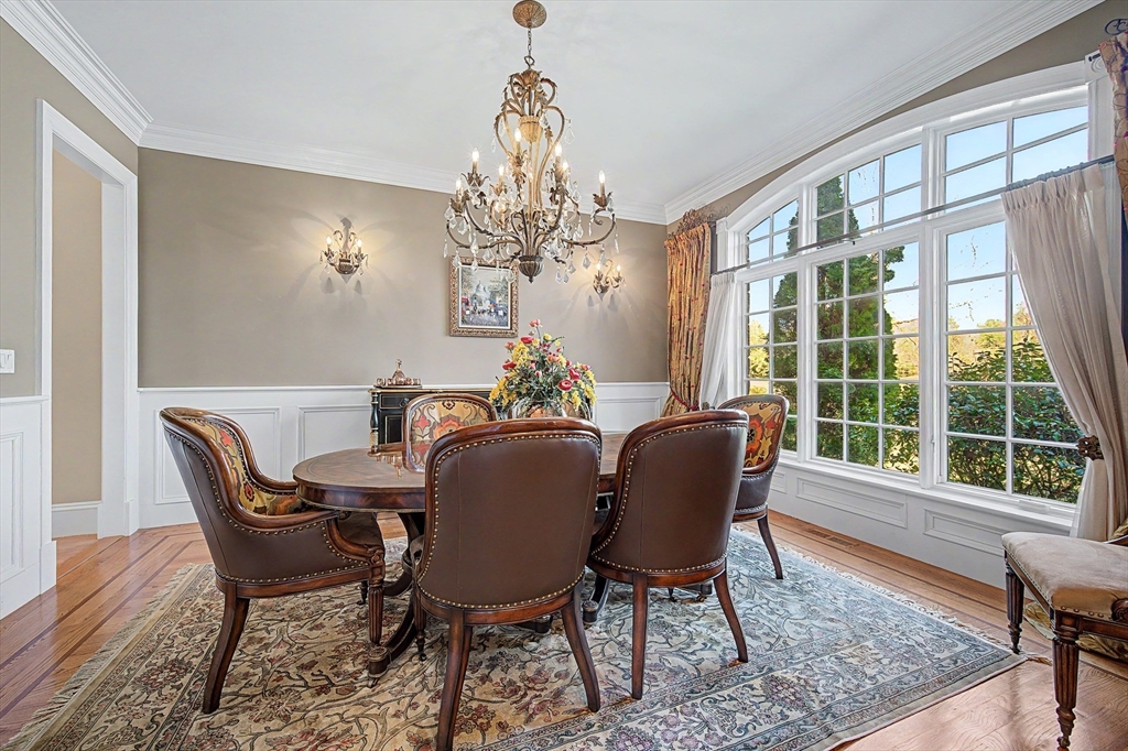 6 Trailside Way Norfolk, MA 02056 - Photo 6 of 42 a dining room with furniture a chandelier and wooden floor