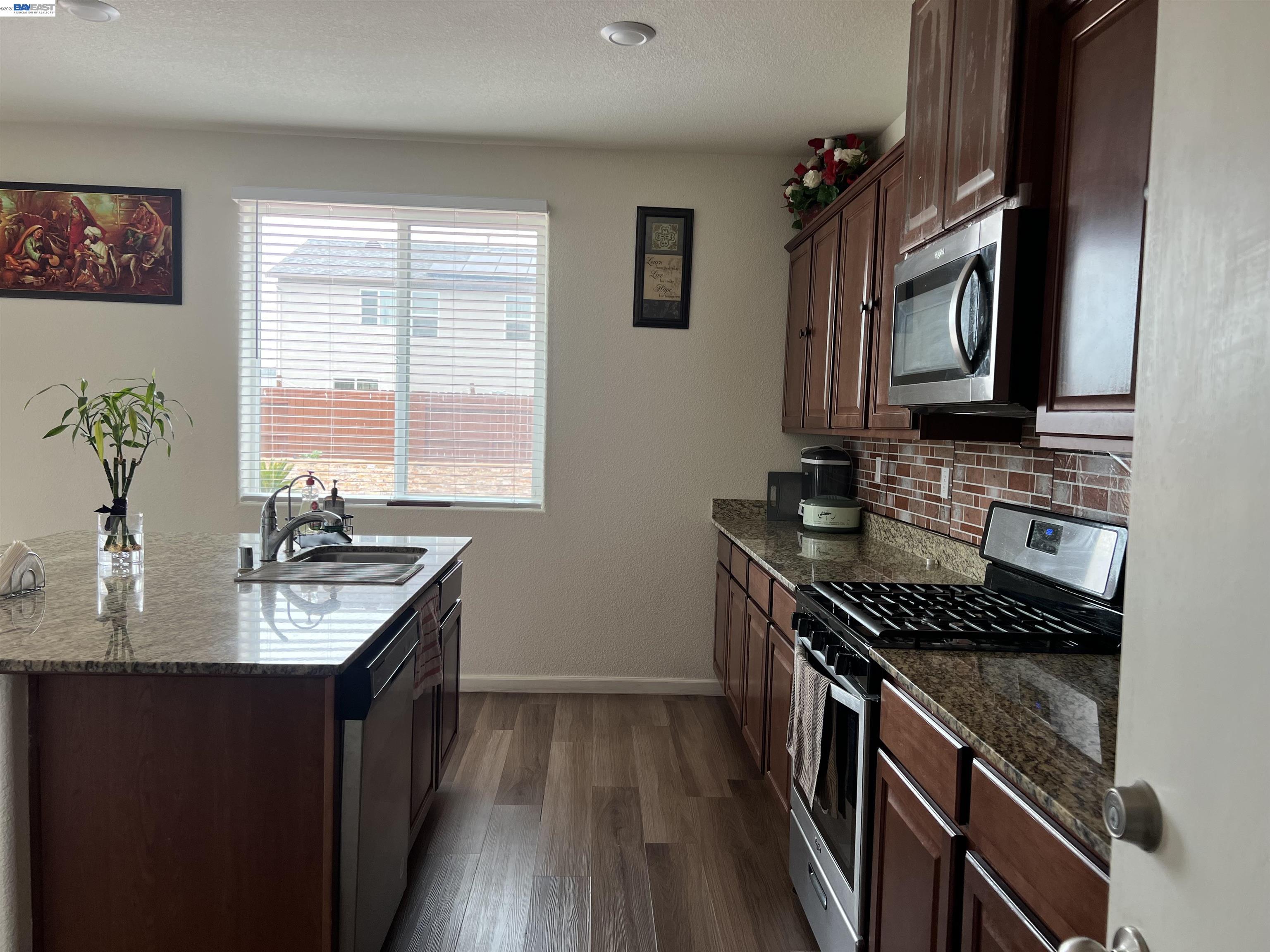 3319 Seger Way Stockton, CA 95212 - Photo 9 of 9 a kitchen with stainless steel appliances granite countertop a sink stove and cabinets