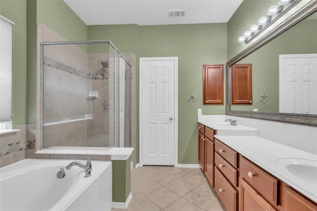 a bathroom with a tub sink and mirror