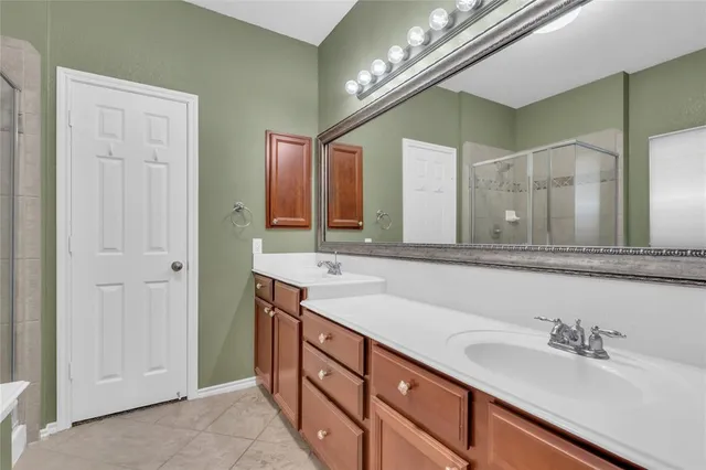 a bathroom with a sink double vanity and a mirror