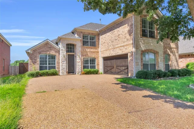 front view of a house with a garden