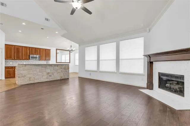 a view of an empty room with a fireplace and a window
