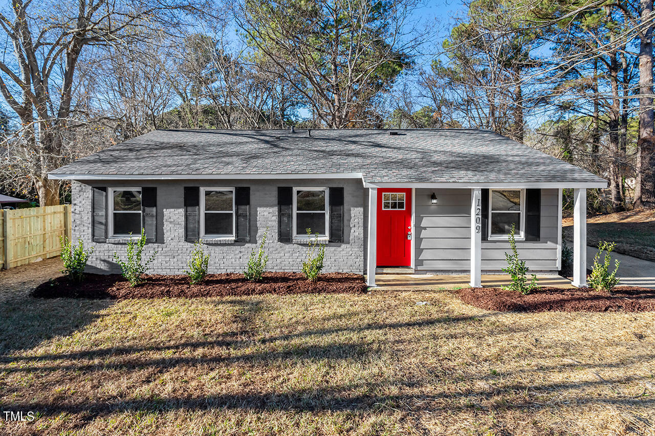 1209 Hazelnut Drive Raleigh, NC 27610 - Photo 1 of 24 a front view of a house with a yard