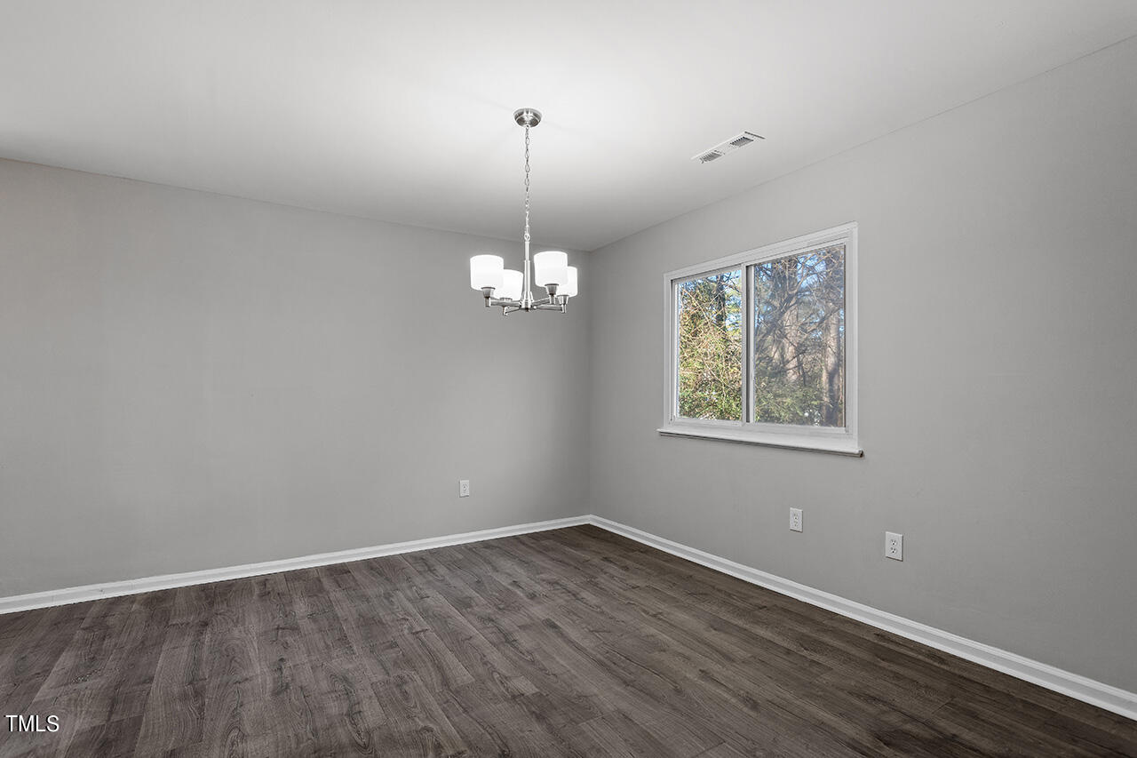 1209 Hazelnut Drive Raleigh, NC 27610 - Photo 12 of 24 wooden floor in an empty room with a window