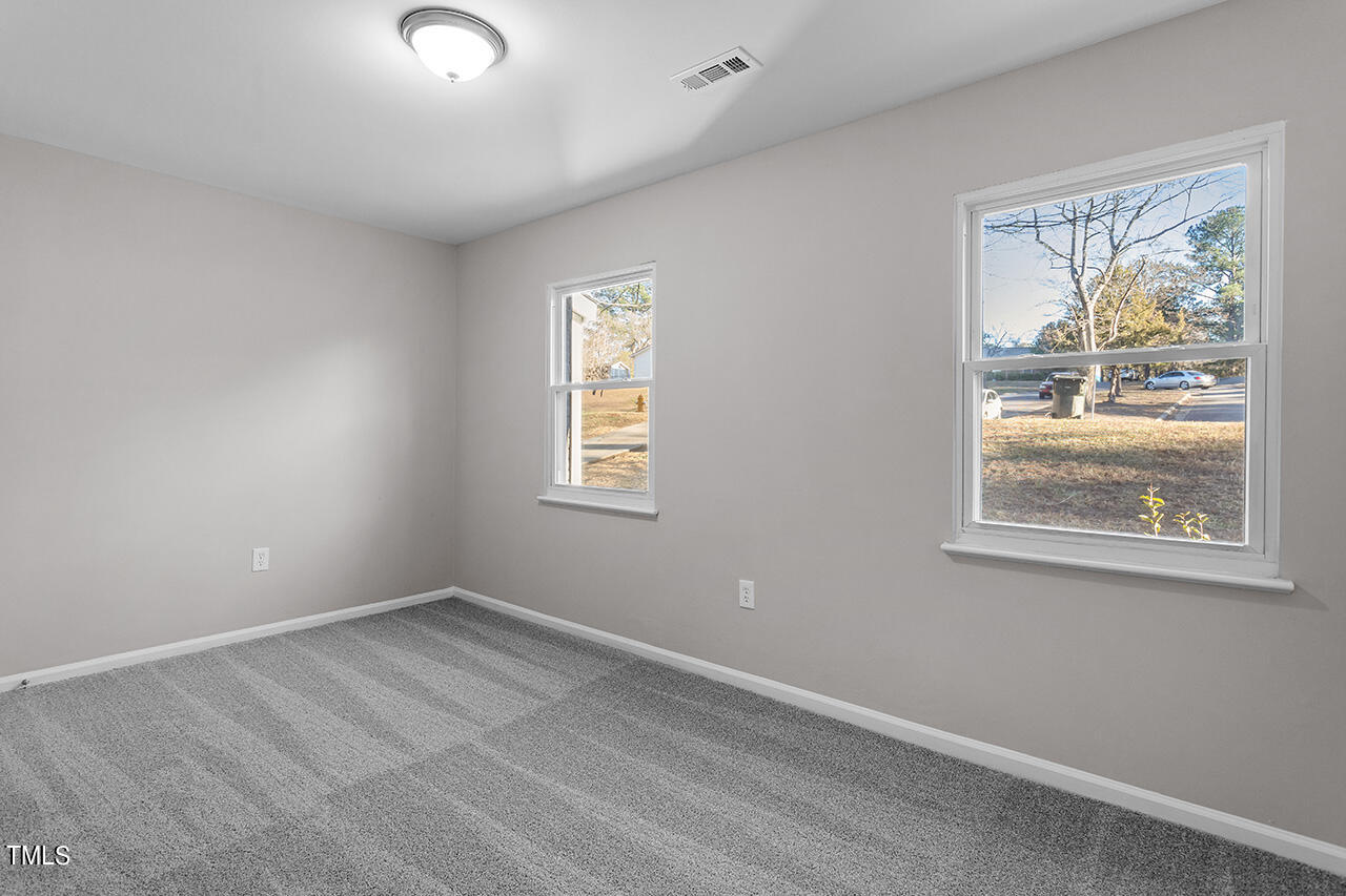 1209 Hazelnut Drive Raleigh, NC 27610 - Photo 13 of 24 an empty room with windows