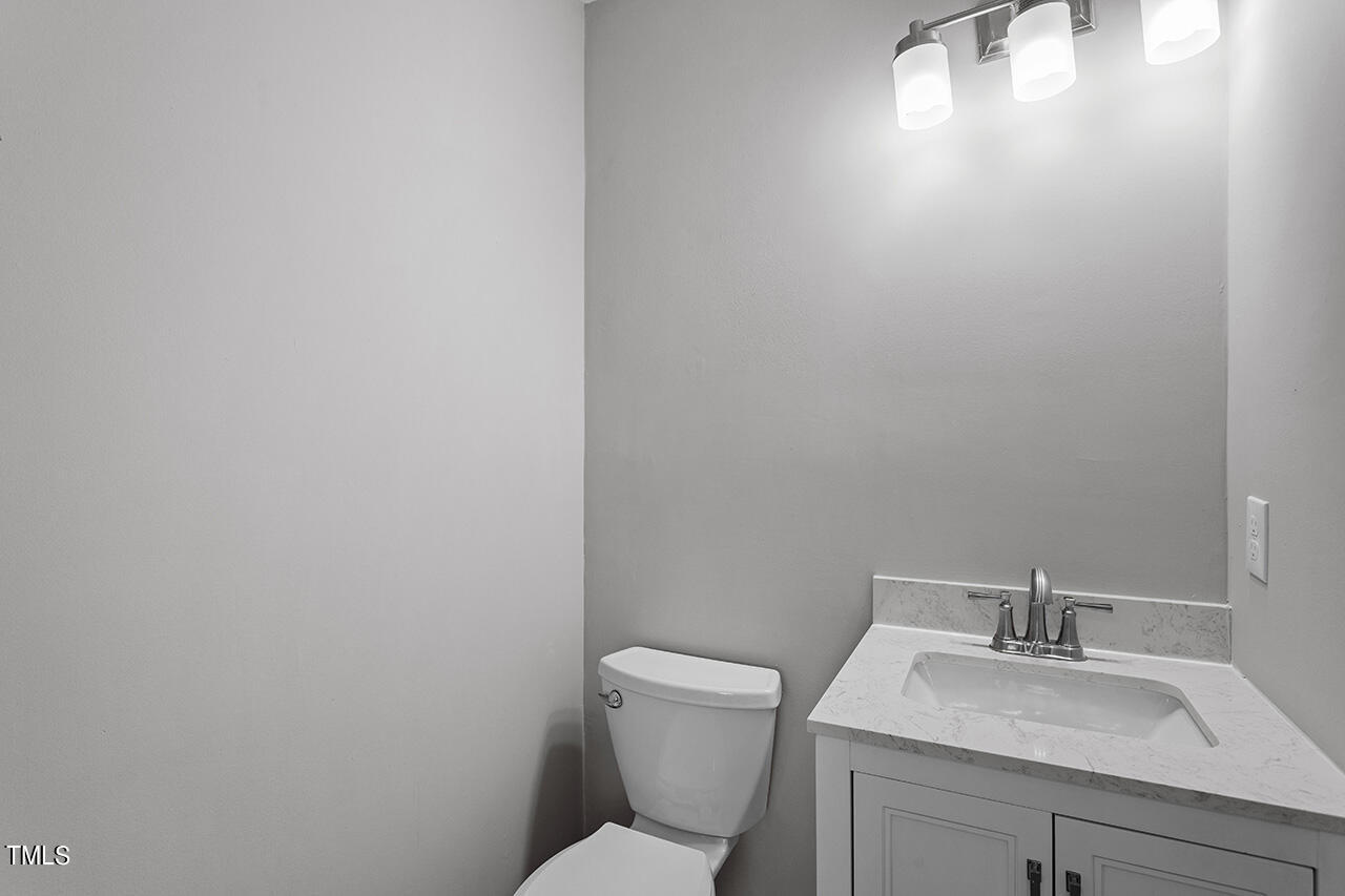 1209 Hazelnut Drive Raleigh, NC 27610 - Photo 16 of 24 a bathroom with a toilet sink and mirror