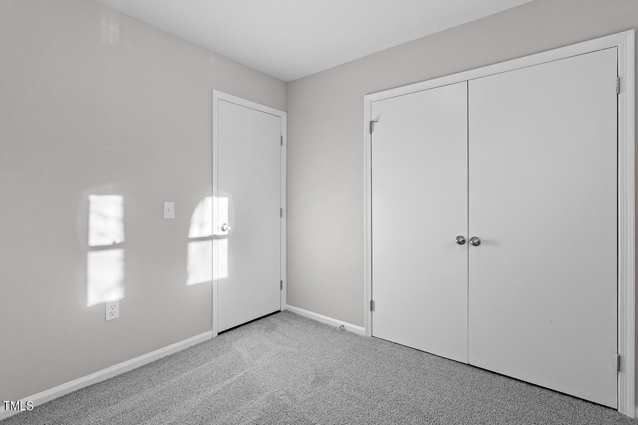 1209 Hazelnut Drive Raleigh, NC 27610 - Photo 18 of 24 a view of an empty room with windows