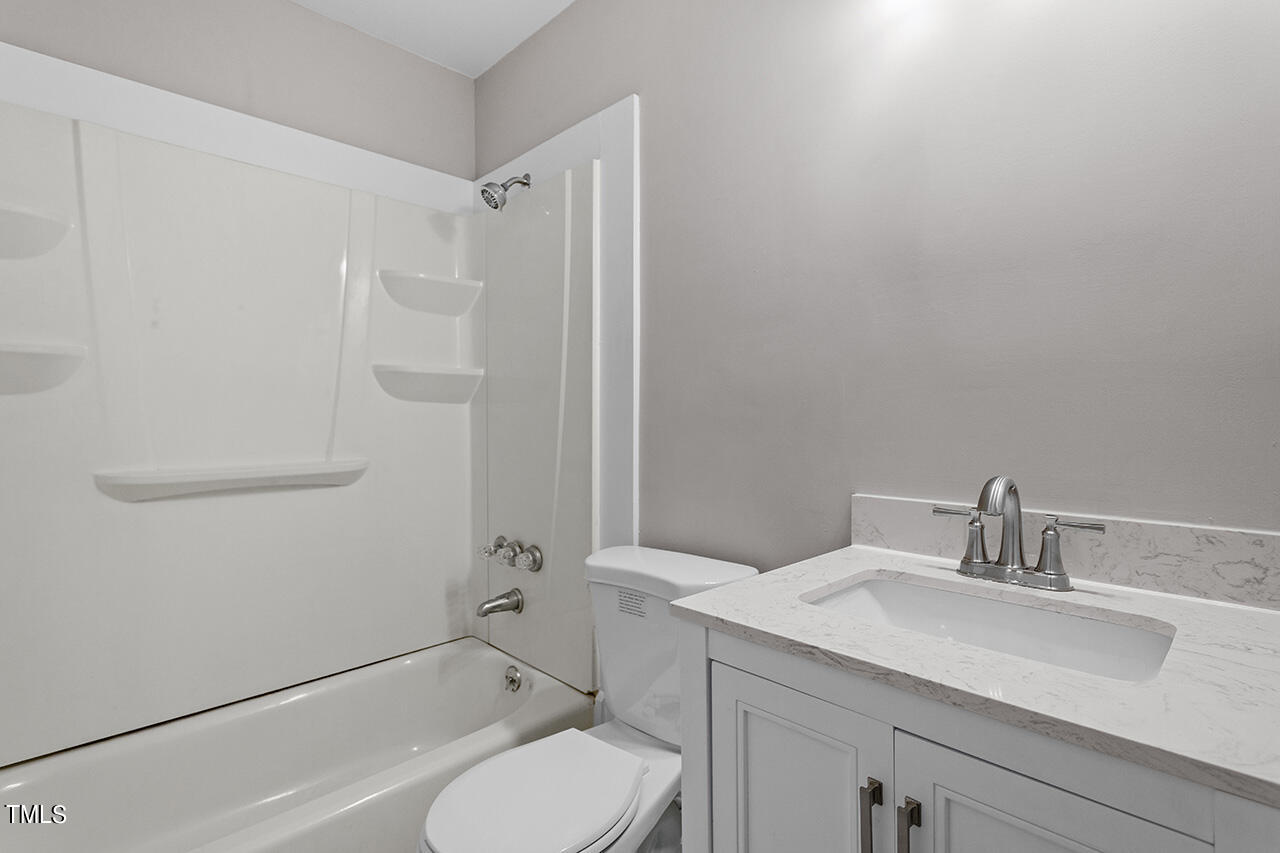 1209 Hazelnut Drive Raleigh, NC 27610 - Photo 20 of 24 a bathroom with a sink toilet and shower