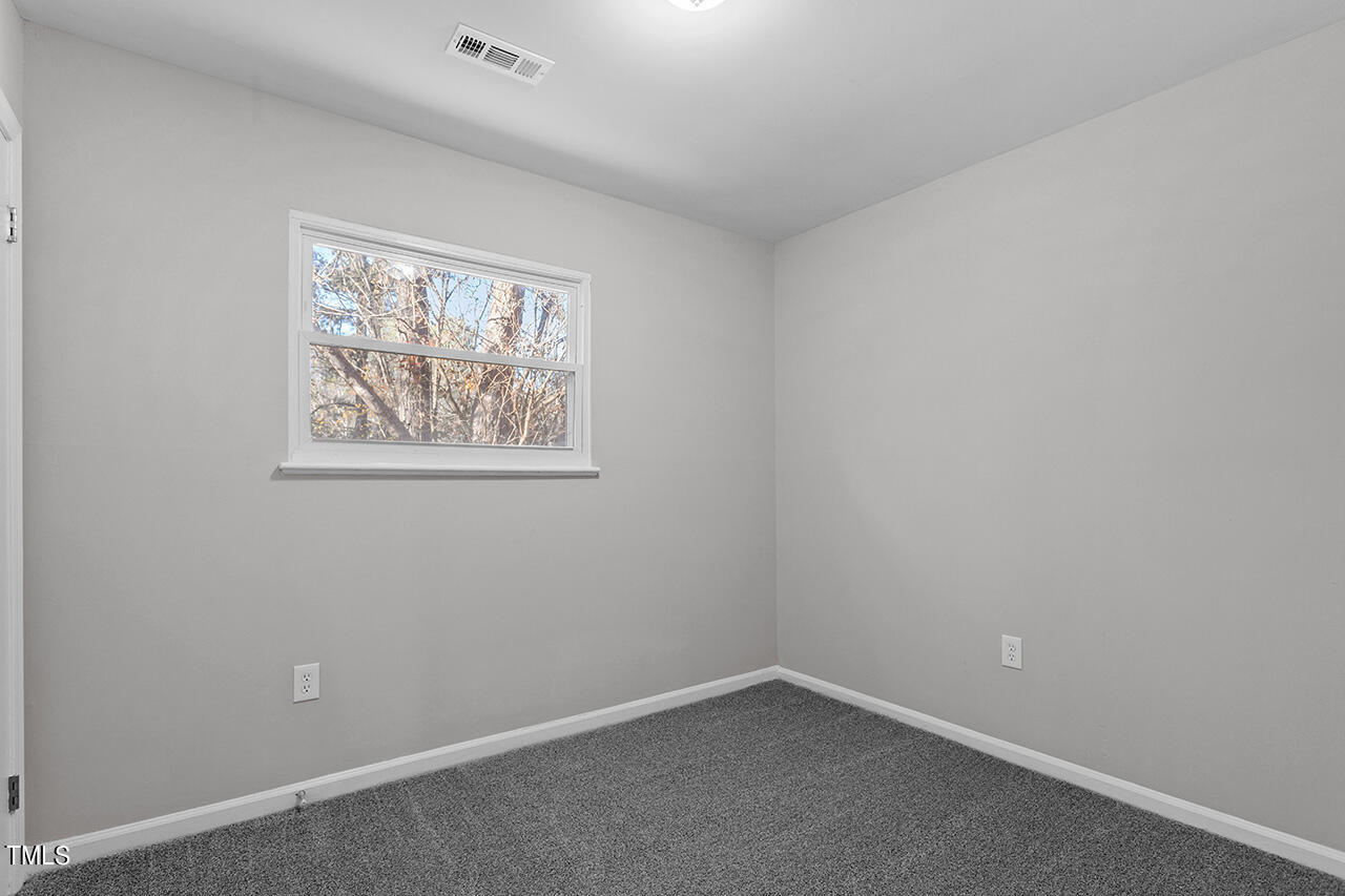 1209 Hazelnut Drive Raleigh, NC 27610 - Photo 21 of 24 an empty room with windows
