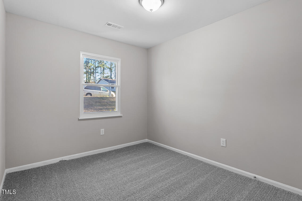 1209 Hazelnut Drive Raleigh, NC 27610 - Photo 22 of 24 an empty room with a window