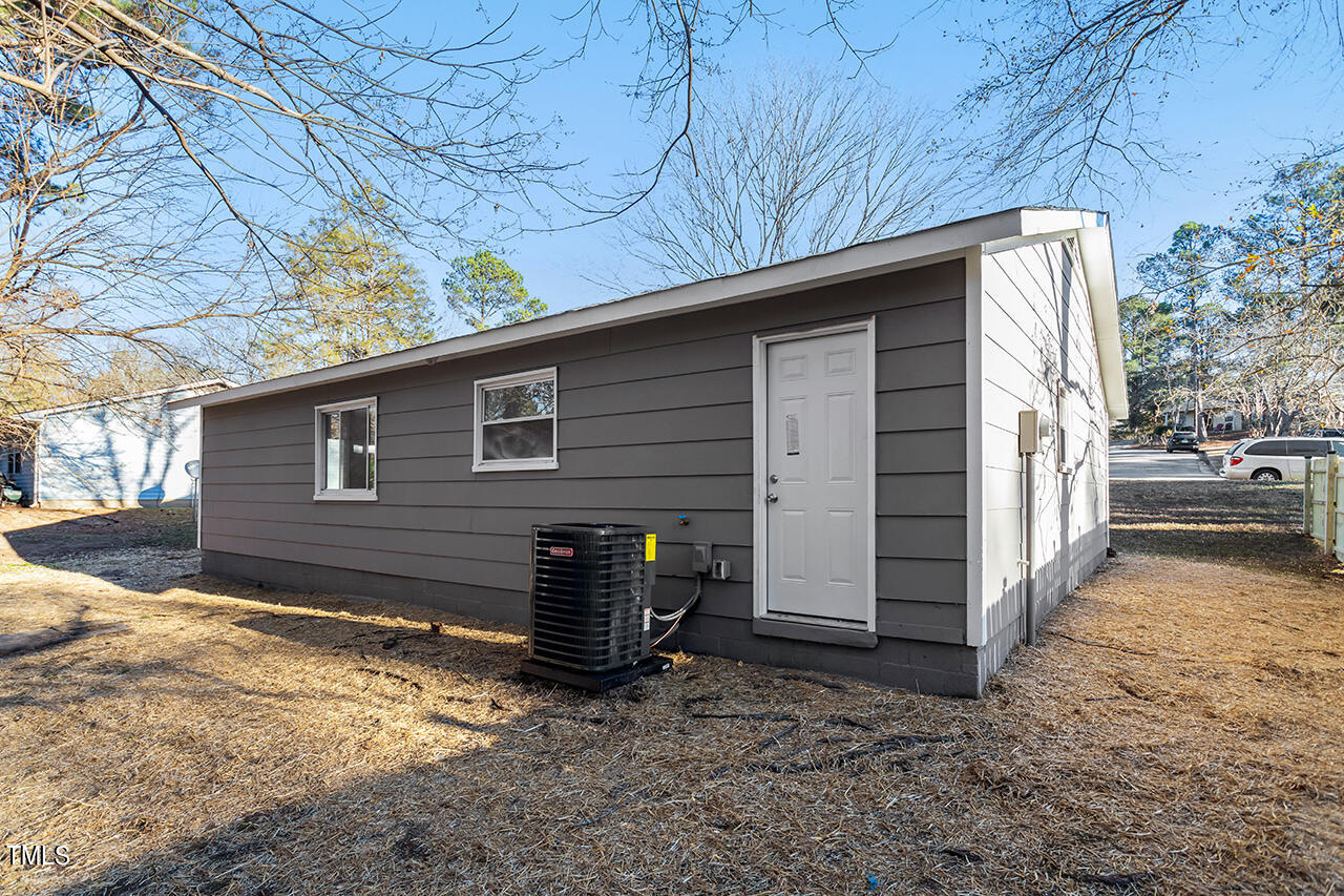 1209 Hazelnut Drive Raleigh, NC 27610 - Photo 23 of 24 a backyard of house with a barbeque and wooden fence