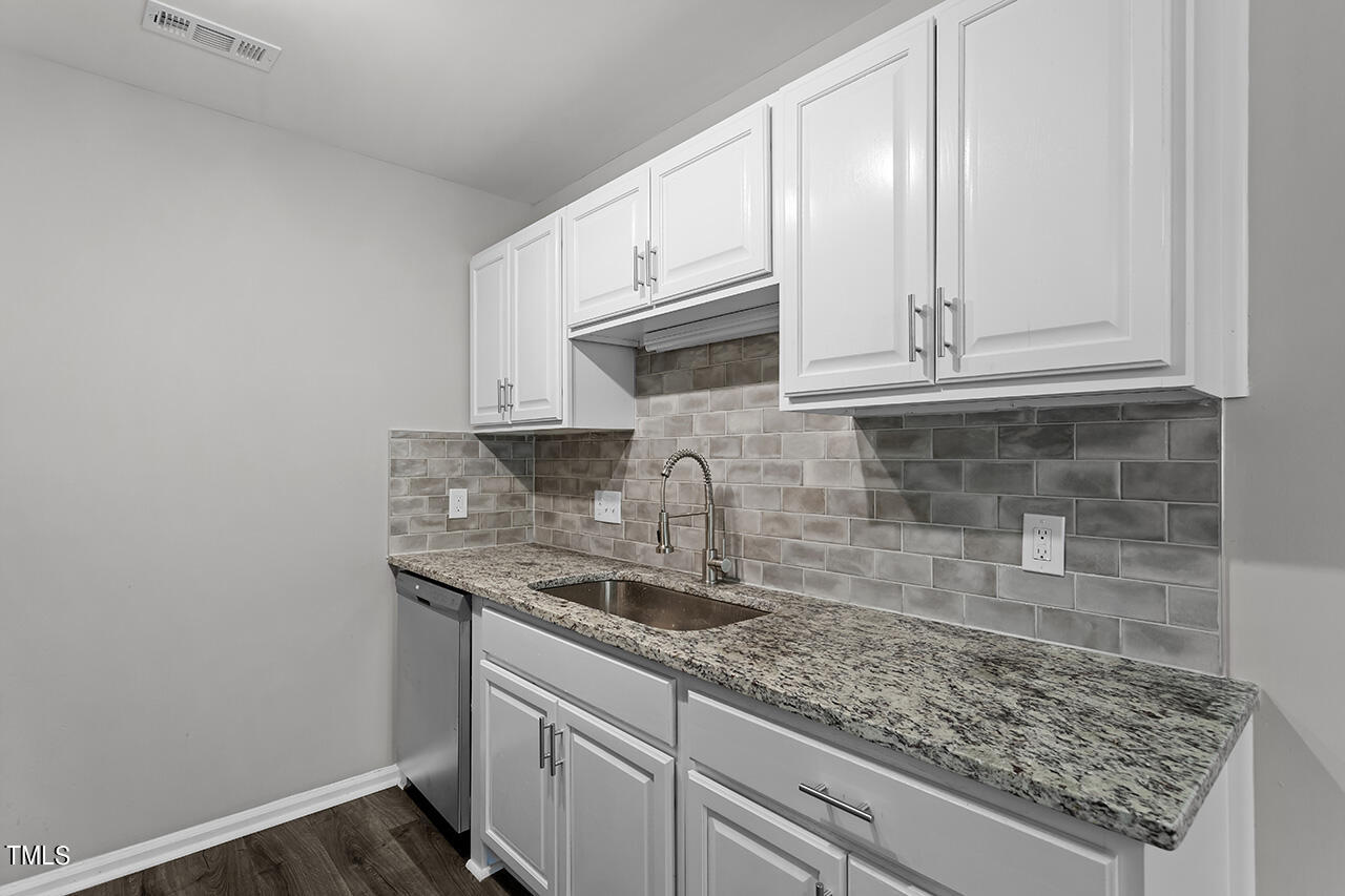 1209 Hazelnut Drive Raleigh, NC 27610 - Photo 3 of 24 a kitchen with granite countertop a sink and cabinets