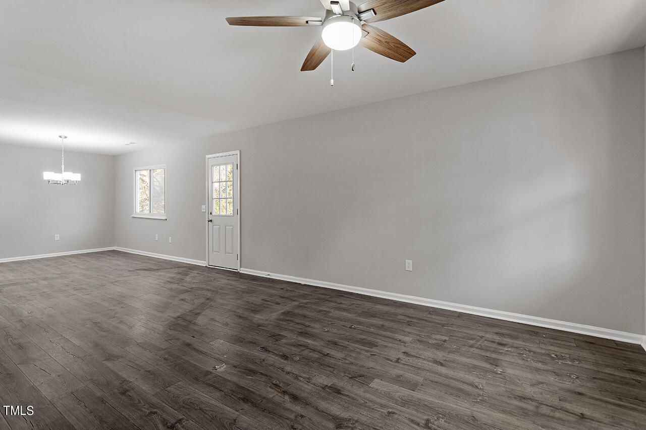 1209 Hazelnut Drive Raleigh, NC 27610 - Photo 7 of 24 a view of an empty room with window and wooden floor