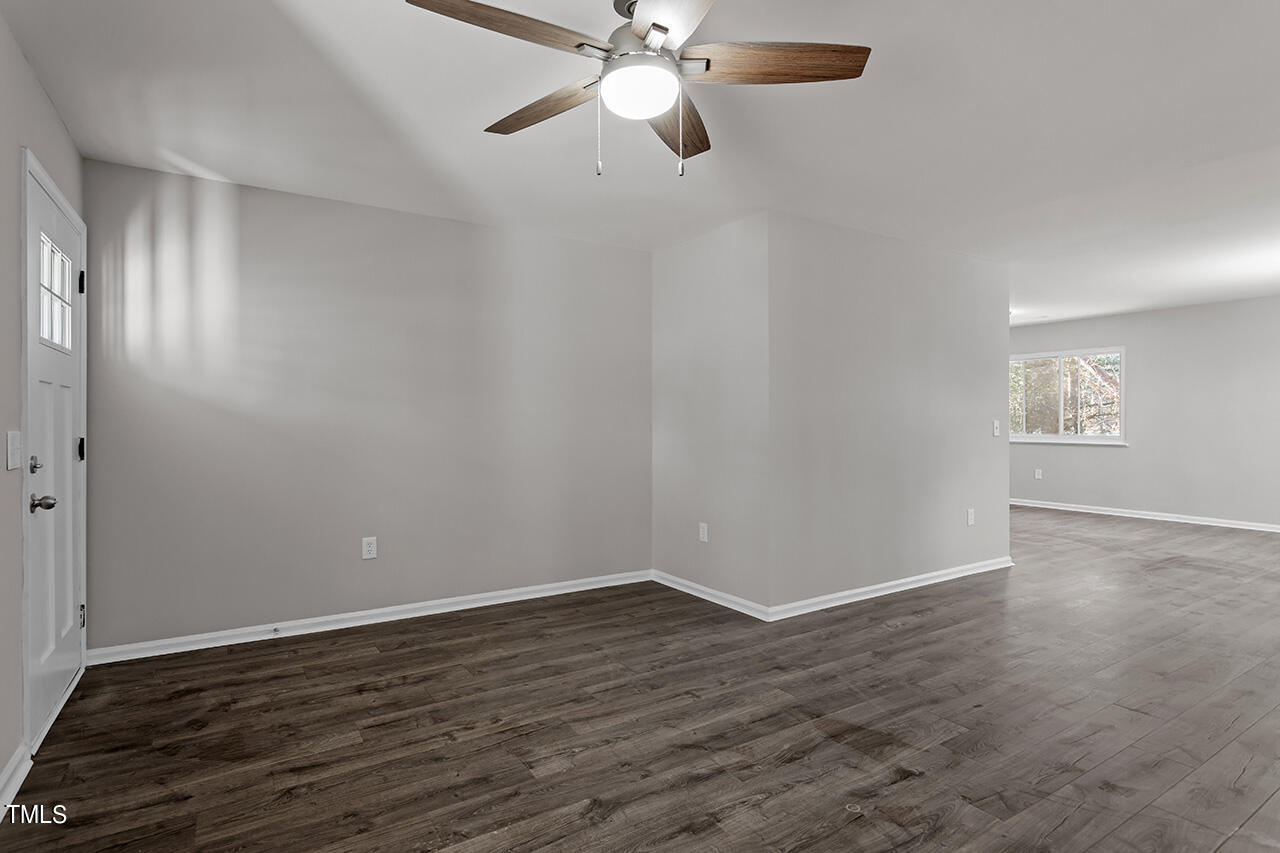 1209 Hazelnut Drive Raleigh, NC 27610 - Photo 8 of 24 a view of an empty room with wooden floor and a window