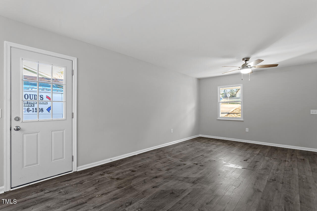 1209 Hazelnut Drive Raleigh, NC 27610 - Photo 10 of 24 an empty room with wooden floor closet and windows