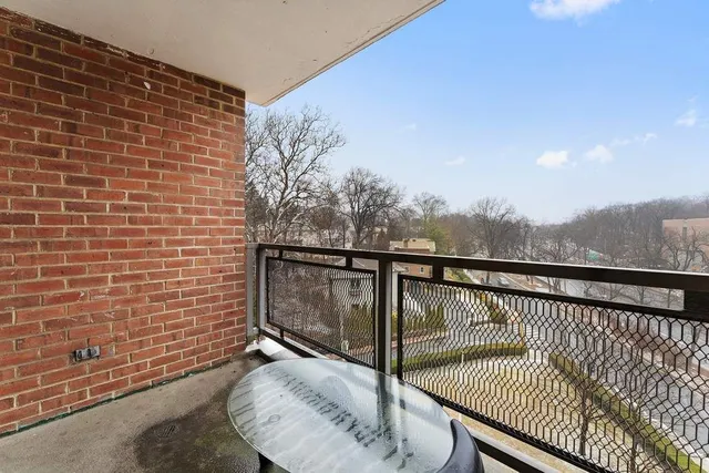 a view of roof deck with wooden floor and fence