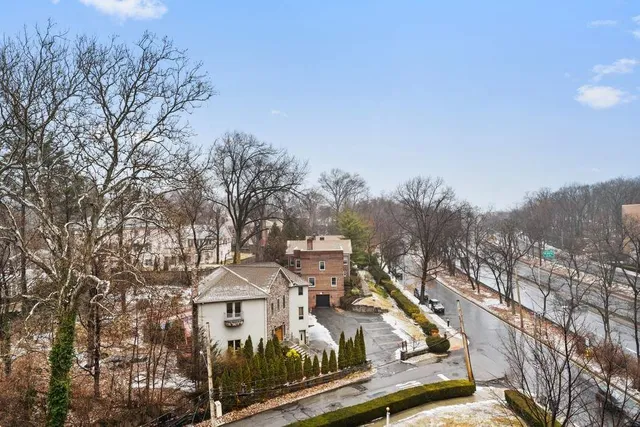 a view of residential houses and trees in the background
