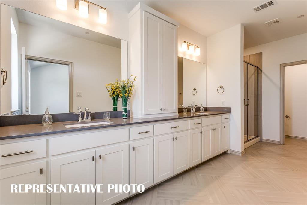 3909 Hessie Road McKinney, TX 75071 - Photo 7 of 15 a spacious bathroom with a granite countertop sink and a mirror