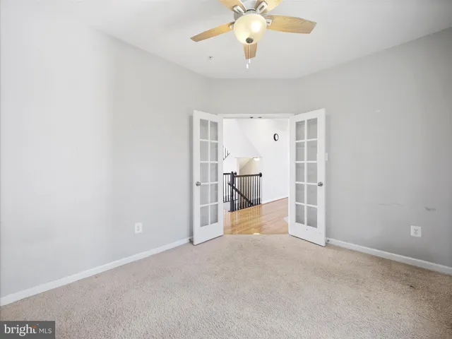 a view of a room with a hanging light and kitchen