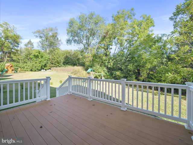 a view of a wooden deck and a yard