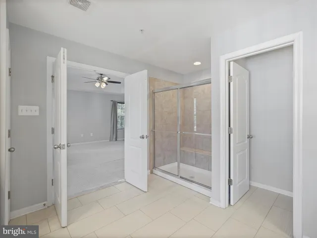 a bathroom with a shower and a glass door