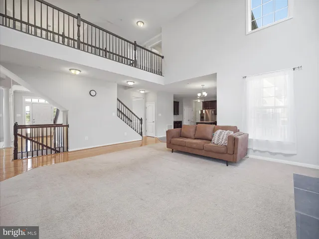 a living room with furniture and a ceiling fan