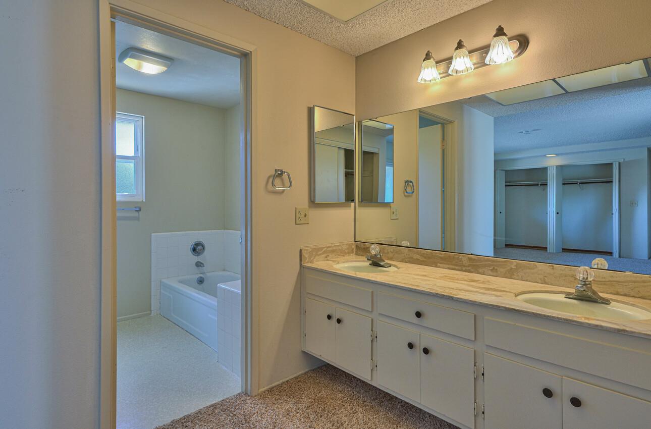 23007 Espada Drive Salinas, CA 93908 - Photo 20 of 39 a bathroom with a granite countertop sink mirror and toilet