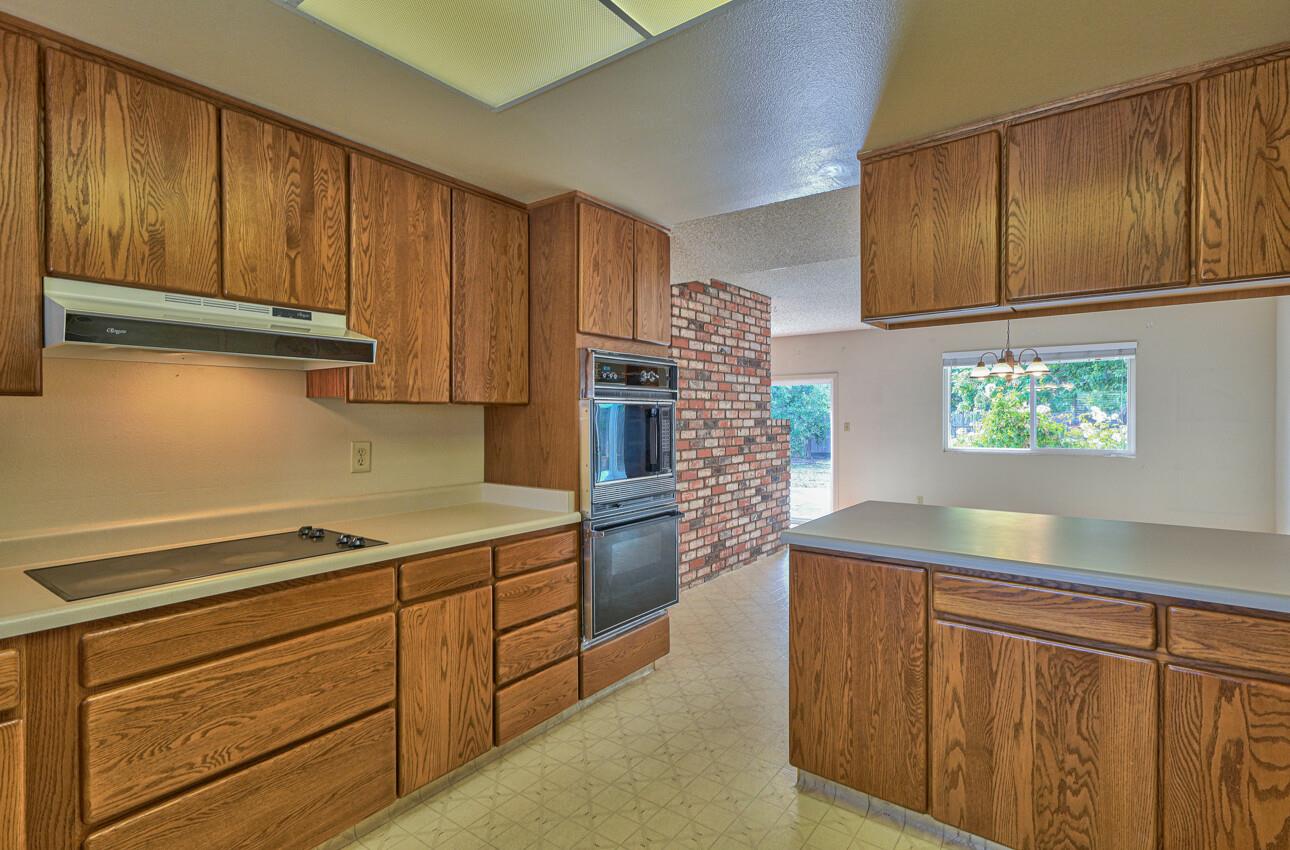 23007 Espada Drive Salinas, CA 93908 - Photo 9 of 39 a kitchen with stainless steel appliances granite countertop wooden cabinets a stove top oven a sink and dishwasher