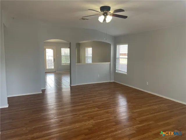 wooden floor in an empty room with a window